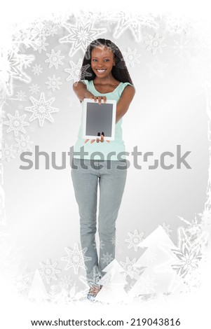 Woman presenting tablet on white background against christmas frame
