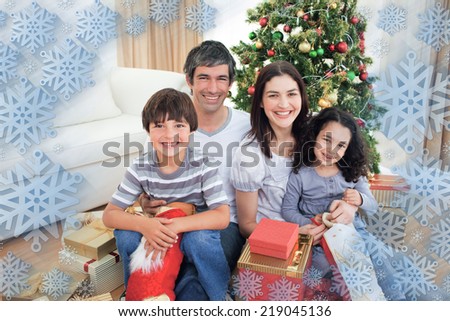 Family Christmas portrait against snowflake frame