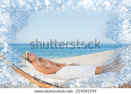 Composite image of snow frame against handsome man relaxing in a hammock