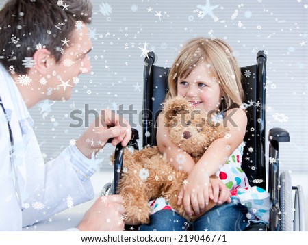 Composite image of Smiling little girl sitting on the wheelchair lokking at the doctor with snow