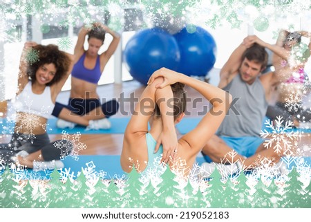 People with trainer stretching hands behind backs against snow