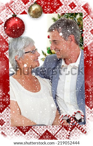 Senior couple in love in Christmas against snow falling