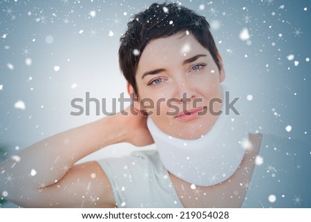 Close up of a woman with a surgical collar against snow falling