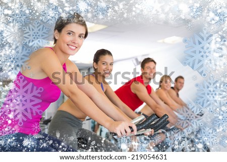 Spin class working out and smiling at camera against snow