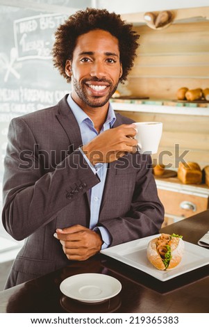 Businessman enjoying his lunch hour at the coffee shop