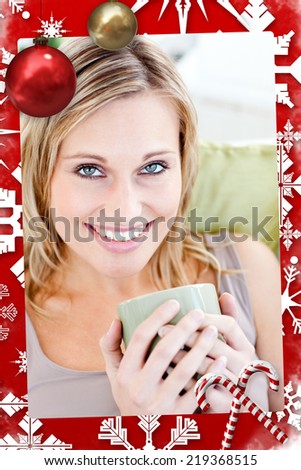 Positive blond woman holding a cup smiling at the camera with christmas themed page