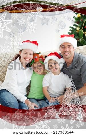Adorable family at Christmas sitting in the livingroom with christmas frame