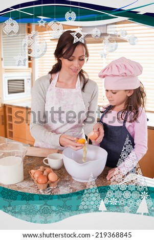 Portrait of a happy mother and her daughter baking against christmas frame