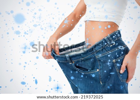 Fit woman wearing too large pants against snow falling