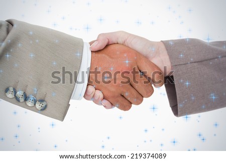 Side view of business peoples hands shaking against twinkling stars