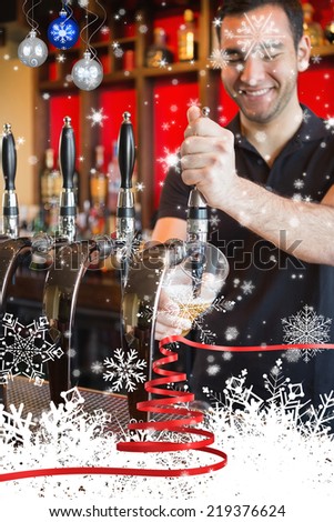 Handsome barkeeper pulling a pint of beer against snow falling