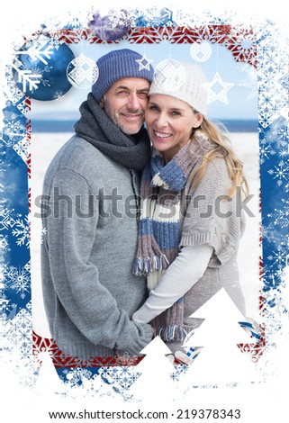 Smiling couple standing on the beach in warm clothing against christmas themed frame