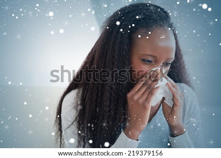 Composite image of close up of woman blowing her nose against snow