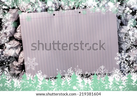 Composite image of snow frame against lined paper notebook on crumpled paper