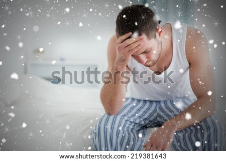 Composite image of ill man sitting on his bed against snow falling