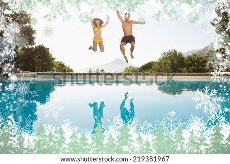 Cheerful couple jumping into swimming pool against snow