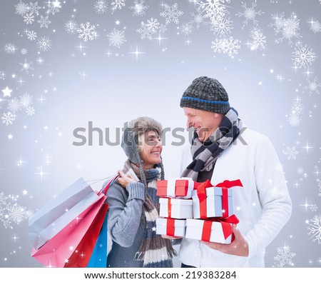 Composite image of woman surprising boyfriend with gift against grey vignette
