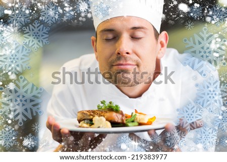 Composite image of snow frame against closeup of a chef with eyes closed smelling food