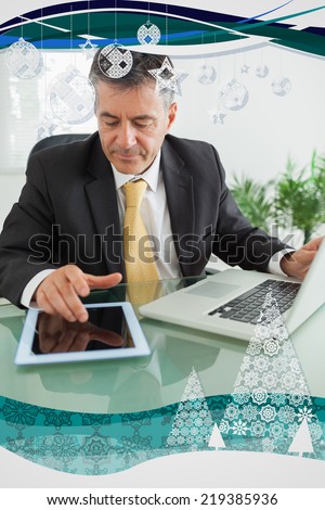 Business man working on digital tablet against christmas frame