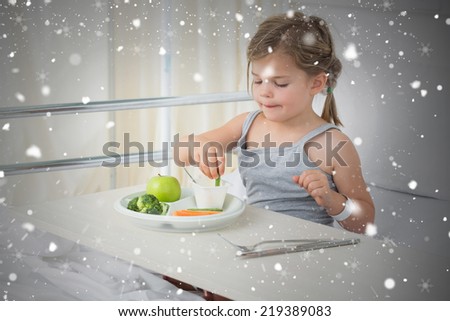Composite image of sick girl with digital tablet in hospital bed against snow falling