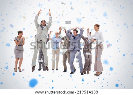 Very happy people with money falling from the sky against snow falling