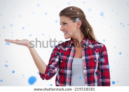 Smiling woman displaying a copy space against snow falling