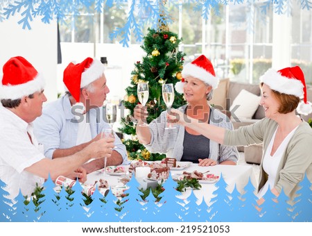 Family toasting a nice meal with frost and fir trees in blue in the foreground