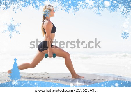 Fit blonde doing weighted lunges on the beach against snow