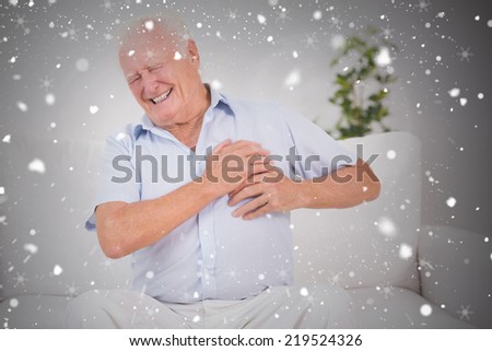 Composite image of old man suffering with heart pain against snow falling