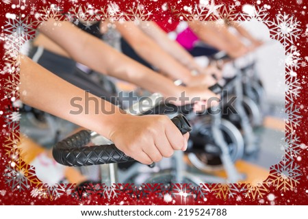 Spin class working out in a row against snow
