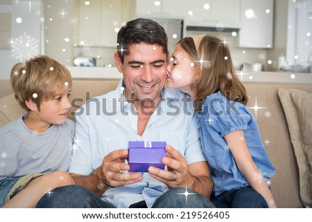 Composite image of Loving children gifting father against snow falling
