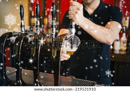 Composite image of Barkeeper pulling a pint of beer against snow falling