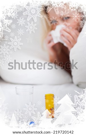 Medicines with a blonde woman sneezing against christmas frame