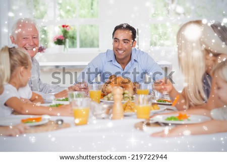 Composite image of Happy family at thanksgiving against snow falling