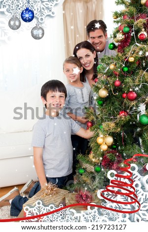 Happy family decorating a Christmas tree with boubles and presents against twinkling stars
