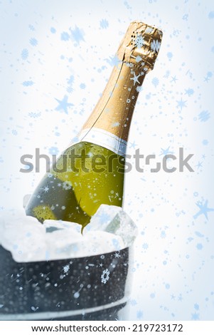 Composite image of snow falling against champagne cooling in ice bucket
