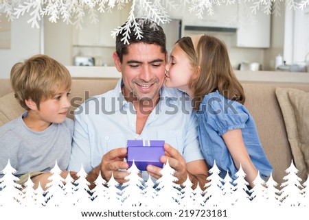 Loving children gifting father against fir tree forest and snowflakes
