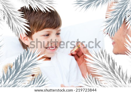 Handsome doctor taking little boys temperature against fir tree branches forming frame