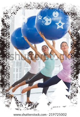 Fitness class doing pilates exercise with fitness balls against christmas themed frame
