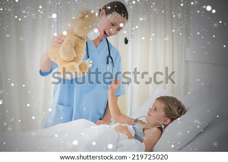 Composite image of doctor entertaining sick girl with teddy bear against snow