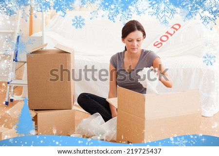 Gorgeous woman packing her property against snow