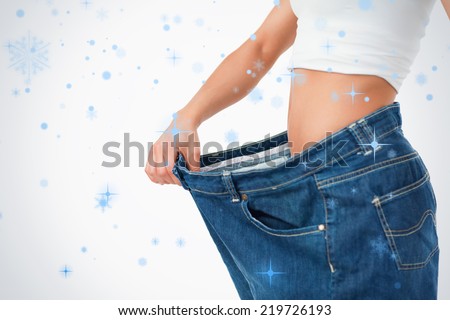 Woman wearing too large pants against snow falling