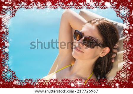 Composite image of cheerful woman by swimming pool against snow