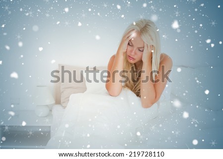 Composite image of woman holding her hand against snow falling