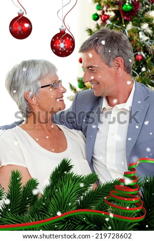 Senior couple in love in Christmas against snow falling