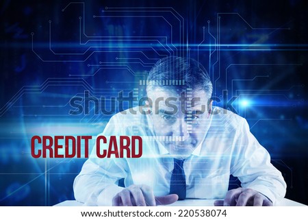 The word credit card and mature businessman typing on keyboard against blue technology interface with circuit board