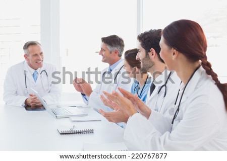 Doctors applauding a fellow doctor for his speech