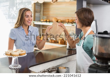 Barista serving a happy customer at the coffee shop