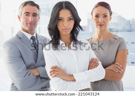 Serious businesswoman with folded arms at work
