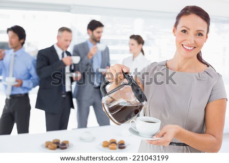 Businesswoman pouring herself some coffee at the office